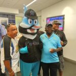 People Clicking Pictures With Baseball Tournament Mascot